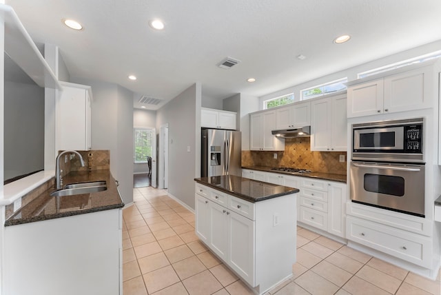 kitchen with a sink, appliances with stainless steel finishes, light tile patterned floors, and visible vents