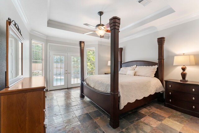 bedroom with french doors, access to exterior, visible vents, a raised ceiling, and stone tile floors