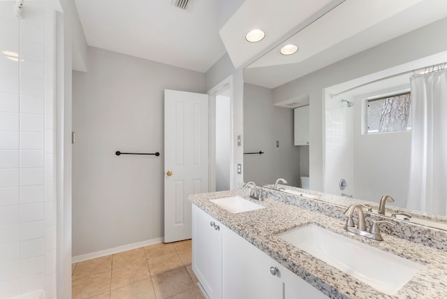 full bath with baseboards, a shower with curtain, a sink, and tile patterned flooring