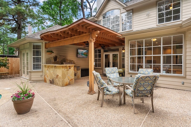 view of patio / terrace with french doors, a ceiling fan, and fence
