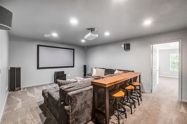 home theater room featuring visible vents, recessed lighting, light carpet, and baseboards