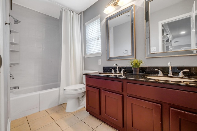 full bathroom with tile patterned floors, shower / tub combo with curtain, toilet, and a sink
