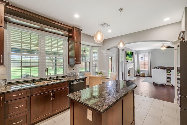 1416 Blueberry Ln, Friendswood, TX 77546 - kitchen with a sink, ornate columns, a fireplace with flush hearth, a kitchen island, and open floor plan