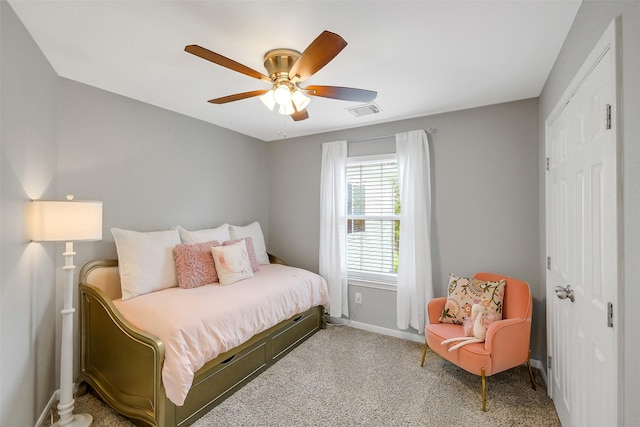 carpeted bedroom with a ceiling fan, visible vents, a closet, and baseboards
