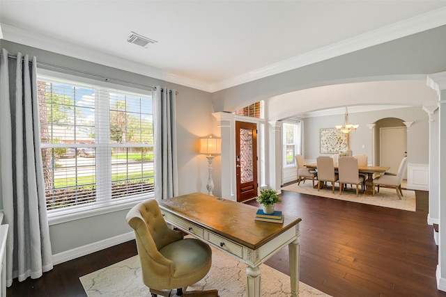 office space with crown molding, visible vents, arched walkways, dark wood-style flooring, and decorative columns