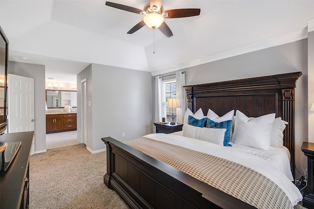 bedroom featuring ceiling fan, ensuite bathroom, baseboards, vaulted ceiling, and light carpet
