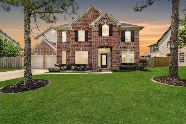 view of front of home with fence, a front lawn, concrete driveway, and brick siding