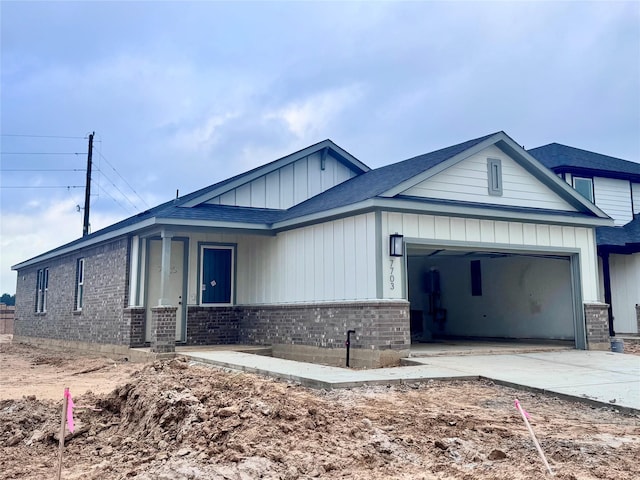 7703 Basil Ridge Dr, Cypress, TX 77433 - view of front of house featuring brick siding, a garage, driveway, and a shingled roof
