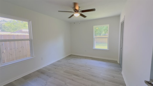 5236 Perry St, Houston, TX 77021 - spare room featuring light wood finished floors, a ceiling fan, and baseboards