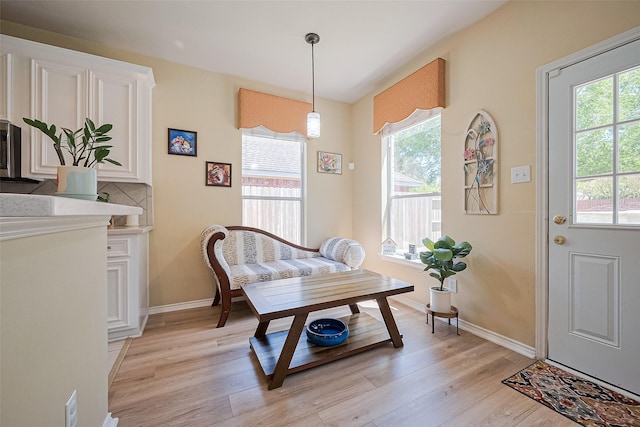 dining area with baseboards, a wealth of natural light, and light wood-style flooring