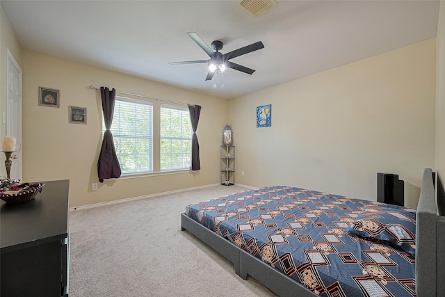 carpeted bedroom with visible vents, ceiling fan, and baseboards