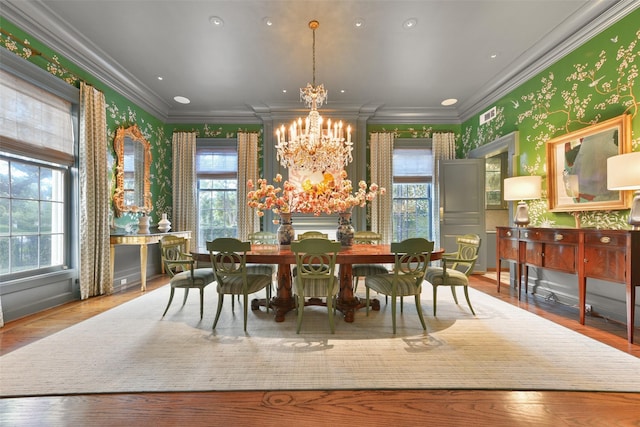 1069 Kirby Dr, Houston, TX 77019 - dining space with crown molding, a wealth of natural light, and a chandelier