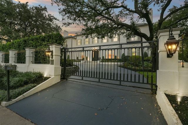 1069 Kirby Dr, Houston, TX 77019 - gate at dusk with a fenced front yard