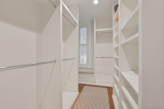 1069 Kirby Dr, Houston, TX 77019 - walk in closet featuring wood finished floors