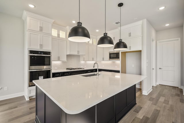 9722 Leafgate Ct, Missouri City, TX 77459 - kitchen featuring baseboards, stainless steel appliances, white cabinetry, and a sink