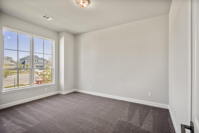 9722 Leafgate Ct, Missouri City, TX 77459 - empty room with baseboards, dark carpet, and a healthy amount of sunlight