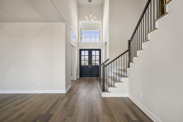 9722 Leafgate Ct, Missouri City, TX 77459 - foyer with stairway, dark wood-type flooring, french doors, a notable chandelier, and a high ceiling