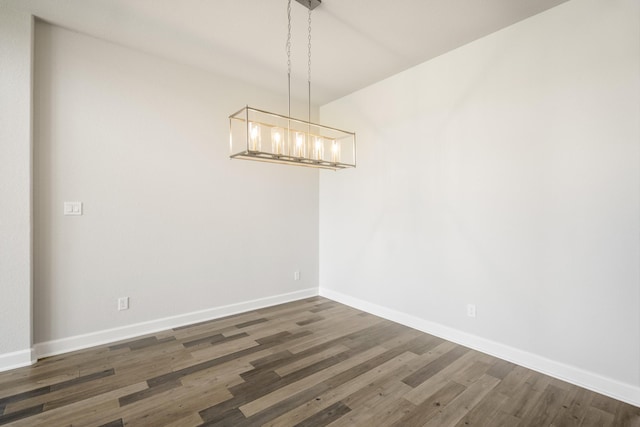 9722 Leafgate Ct, Missouri City, TX 77459 - unfurnished dining area with baseboards, wood finished floors, and an inviting chandelier