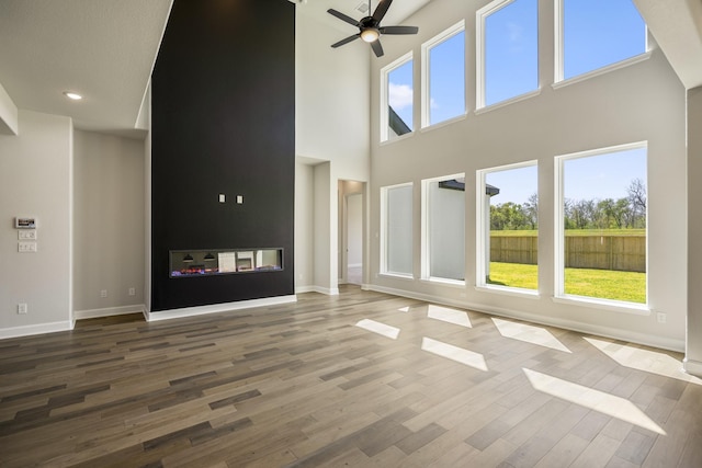 9722 Leafgate Ct, Missouri City, TX 77459 - unfurnished living room with a high ceiling, ceiling fan, wood finished floors, and plenty of natural light