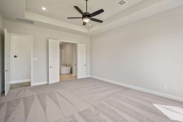 9722 Leafgate Ct, Missouri City, TX 77459 - unfurnished bedroom with carpet flooring, visible vents, and a tray ceiling