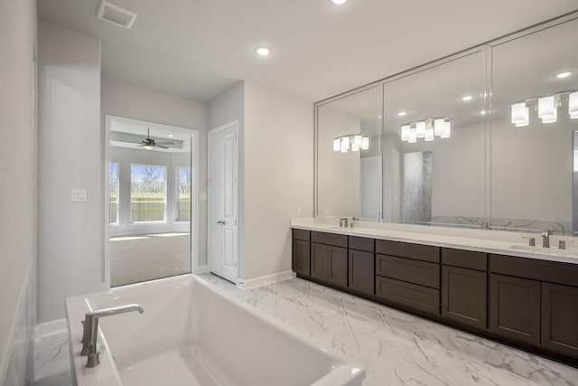 9722 Leafgate Ct, Missouri City, TX 77459 - bathroom with baseboards, visible vents, a bathtub, and a sink