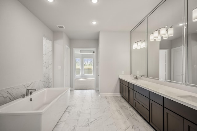 9722 Leafgate Ct, Missouri City, TX 77459 - full bath with visible vents, recessed lighting, a sink, and marble finish floor