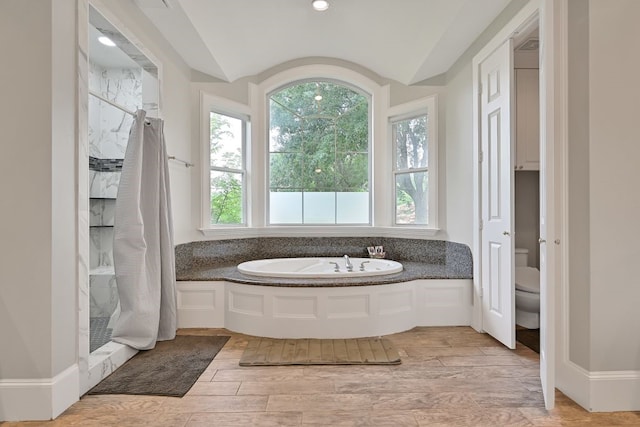 310 Rustic Ln, Friendswood, TX 77546 - full bath with toilet, a garden tub, walk in shower, lofted ceiling, and wood finished floors