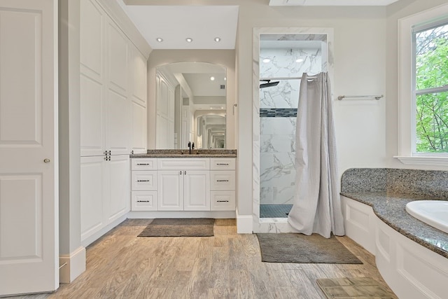 310 Rustic Ln, Friendswood, TX 77546 - full bathroom featuring a marble finish shower, vanity, wood finished floors, recessed lighting, and a tub