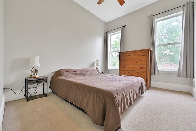 310 Rustic Ln, Friendswood, TX 77546 - bedroom with light carpet, lofted ceiling, multiple windows, and a ceiling fan
