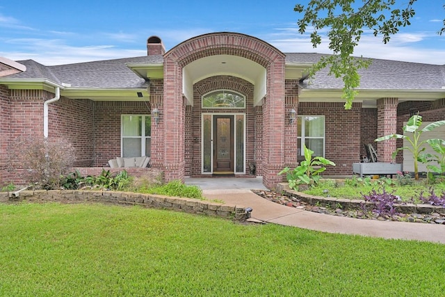 310 Rustic Ln, Friendswood, TX 77546 - entrance to property featuring brick siding, a lawn, a shingled roof, and a chimney