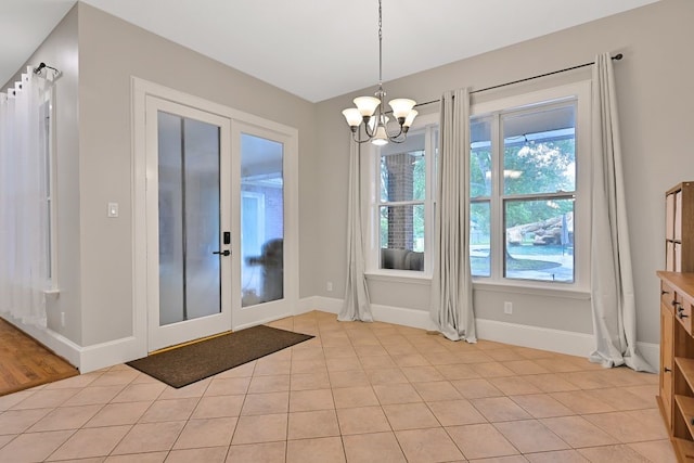 310 Rustic Ln, Friendswood, TX 77546 - entryway with french doors, a chandelier, healthy amount of natural light, and baseboards