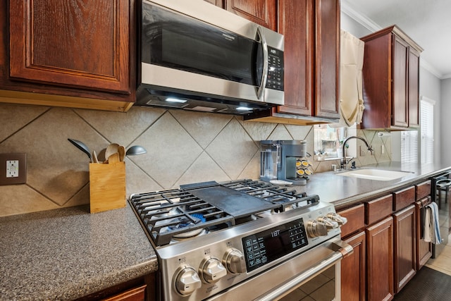 8522 E Highlands Xing, Highlands, TX 77562 - kitchen featuring ornamental molding, a sink, stainless steel appliances, and tasteful backsplash