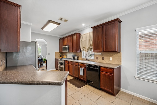 8522 E Highlands Xing, Highlands, TX 77562 - kitchen with arched walkways, appliances with stainless steel finishes, a sink, visible vents, and crown molding