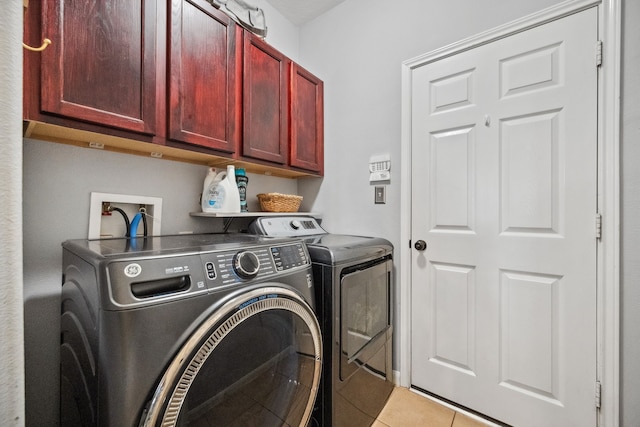 8522 E Highlands Xing, Highlands, TX 77562 - laundry room featuring light tile patterned floors, washer and dryer, and cabinet space