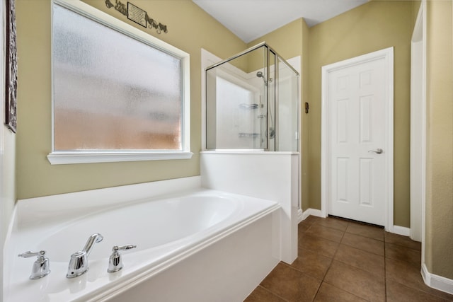 8522 E Highlands Xing, Highlands, TX 77562 - bathroom with tile patterned floors, baseboards, a shower stall, and a bath