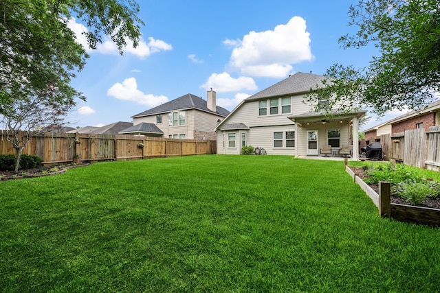 8522 E Highlands Xing, Highlands, TX 77562 - back of property featuring a patio, ceiling fan, a fenced backyard, and a yard