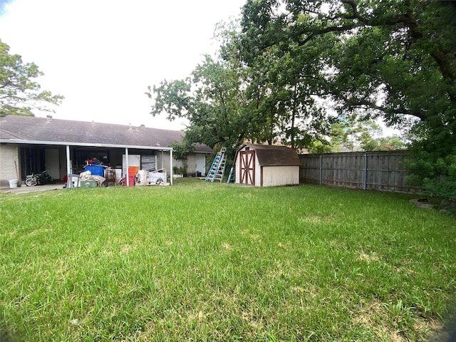 view of yard with an outdoor structure, a storage shed, and fence