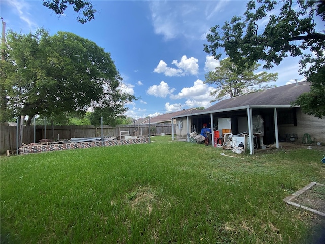 view of yard with a fire pit and a fenced backyard