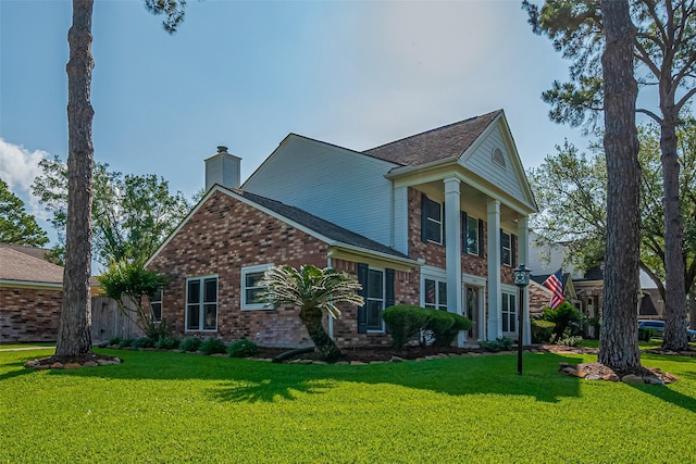 17022 Shadow Valley Dr, Spring, TX 77379 - view of home's exterior with brick siding, a lawn, and a chimney