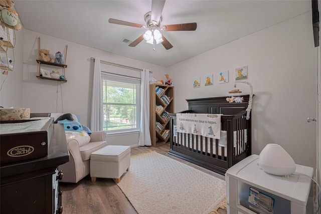 17022 Shadow Valley Dr, Spring, TX 77379 - bedroom with a nursery area, wood finished floors, and a ceiling fan