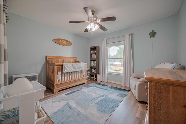 17022 Shadow Valley Dr, Spring, TX 77379 - bedroom featuring wood finished floors, a ceiling fan, and a nursery area