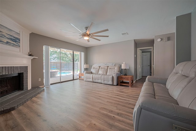 17022 Shadow Valley Dr, Spring, TX 77379 - living area featuring ceiling fan, wood finished floors, and a fireplace