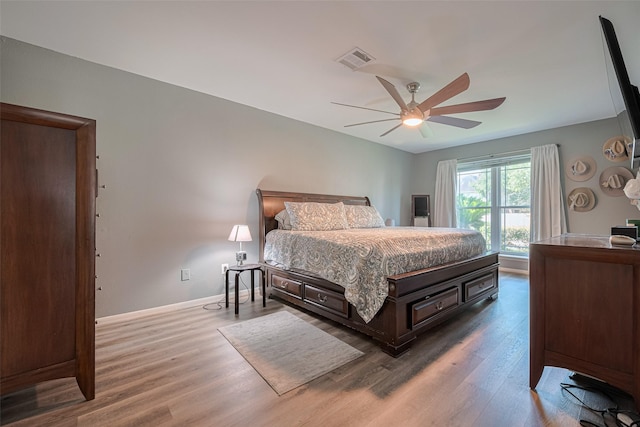 17022 Shadow Valley Dr, Spring, TX 77379 - bedroom with wood finished floors, a ceiling fan, and baseboards