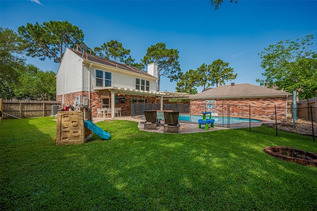 17022 Shadow Valley Dr, Spring, TX 77379 - rear view of house featuring central air condition unit, a chimney, brick siding, and a patio