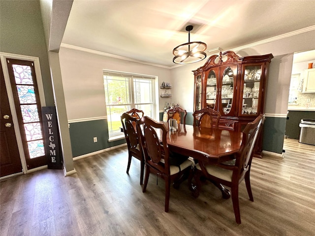 17022 Shadow Valley Dr, Spring, TX 77379 - dining area with crown molding, a chandelier, wood finished floors, and baseboards