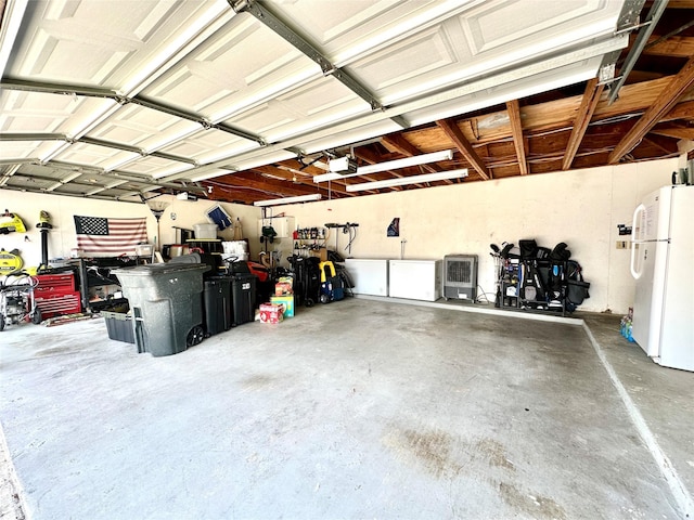 17022 Shadow Valley Dr, Spring, TX 77379 - garage featuring freestanding refrigerator and a garage door opener