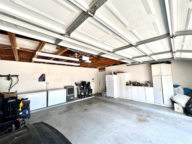 17022 Shadow Valley Dr, Spring, TX 77379 - garage featuring freestanding refrigerator and a garage door opener