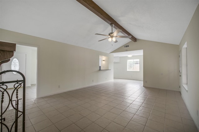 unfurnished room featuring lofted ceiling with beams, tile patterned floors, a ceiling fan, baseboards, and visible vents