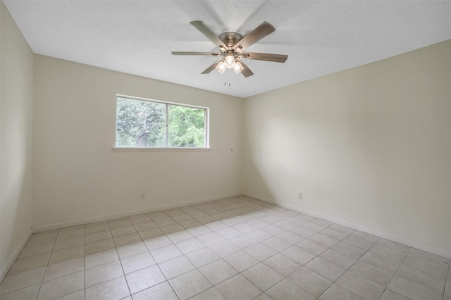 unfurnished room featuring baseboards, a ceiling fan, and light tile patterned flooring