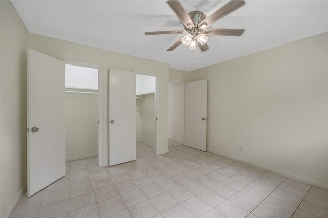 unfurnished bedroom featuring light tile patterned floors, baseboards, and ceiling fan